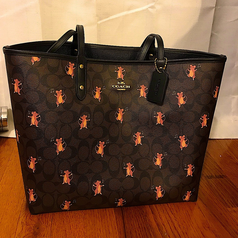 Brown and black Coach bag, with little mice and music notes. Tags still on it.